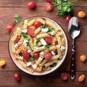 A pasta salad with a balanced mix of vegetables, herbs, and cheese