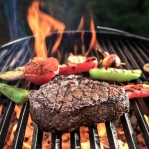 Chuck eye steak cooking on a grill