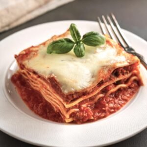 Layers of traditional lasagna with ricotta and marinara sauce