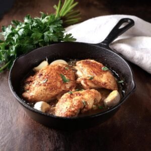 Chicken cooking in a skillet