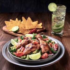 Mexican salad served with grilled chicken and a glass of agua fresca