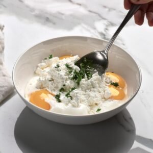 A bowl of ricotta mixed with eggs and seasonings