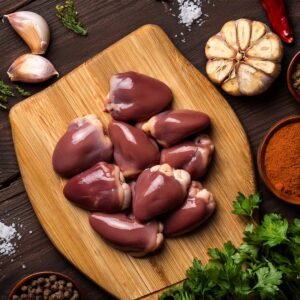 A comparison of chicken hearts to dark chicken meat with seasoning ingredients around.