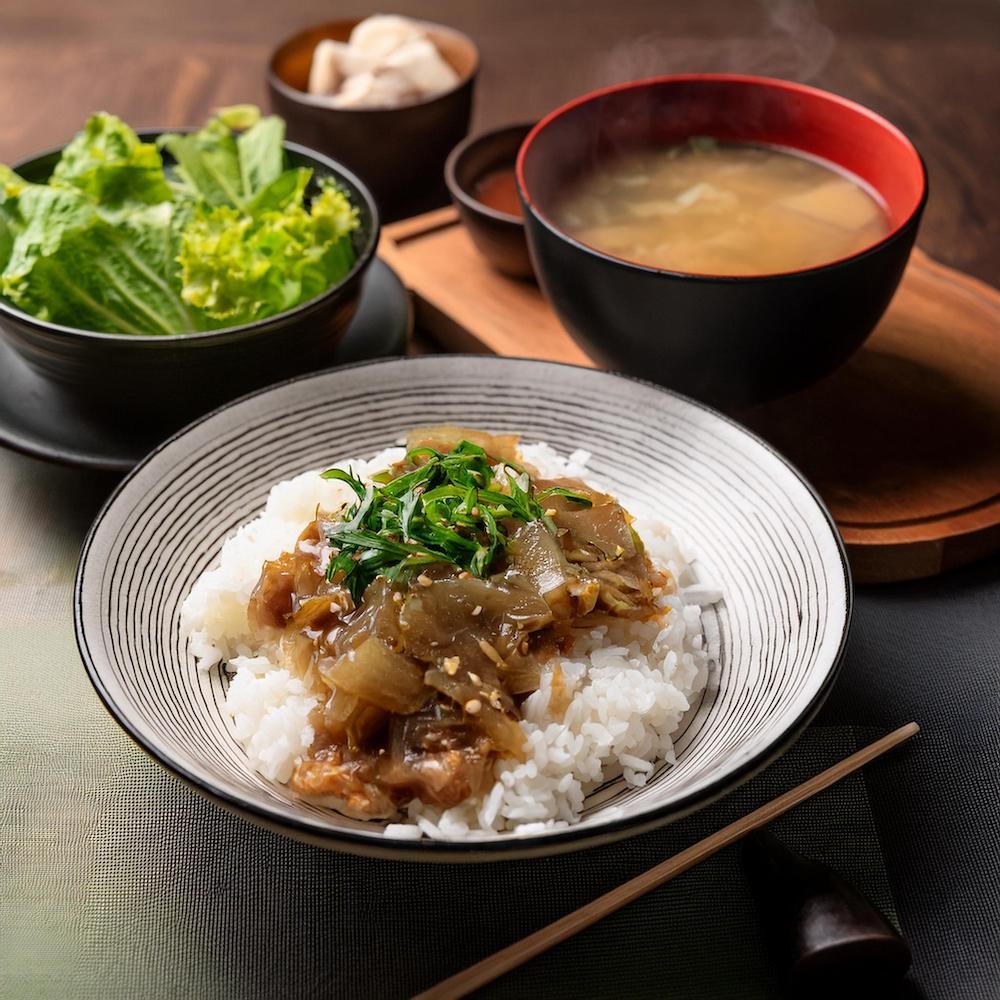 A bowl of hayashi rice served with a side salad and miso soup.