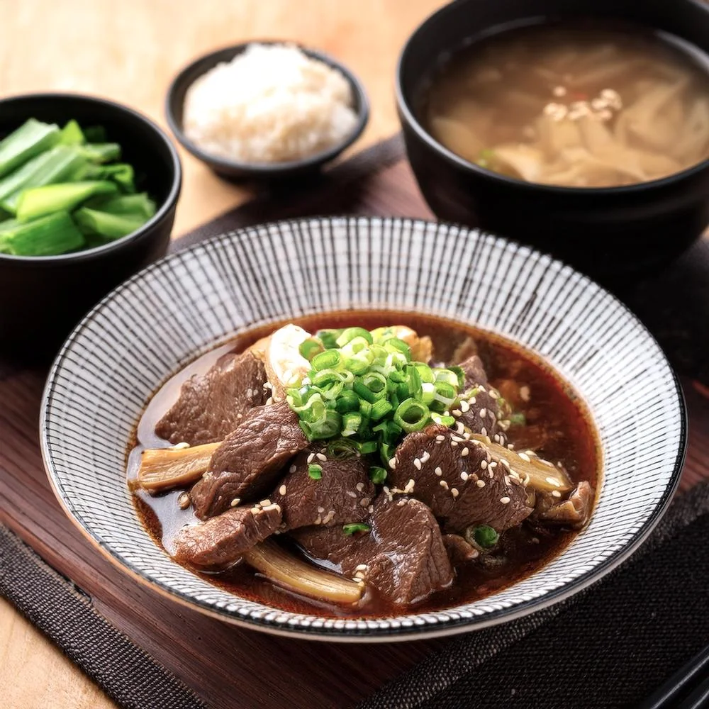 Japanese beef stew garnished with chopped green onions and sesame seeds