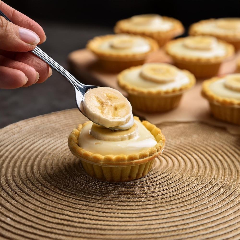 Filling mini banana cream pies with banana pudding