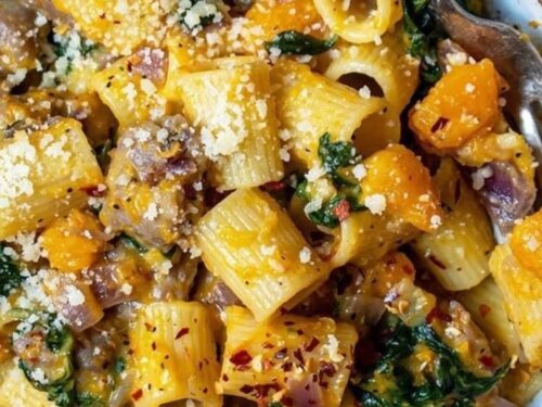 Creamy butternut squash pasta with sausage and spinach served in a bowl