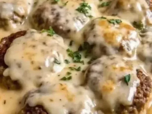 Amish Hamburger Steak Bake served in a rustic dish with rich gravy and seasonings.