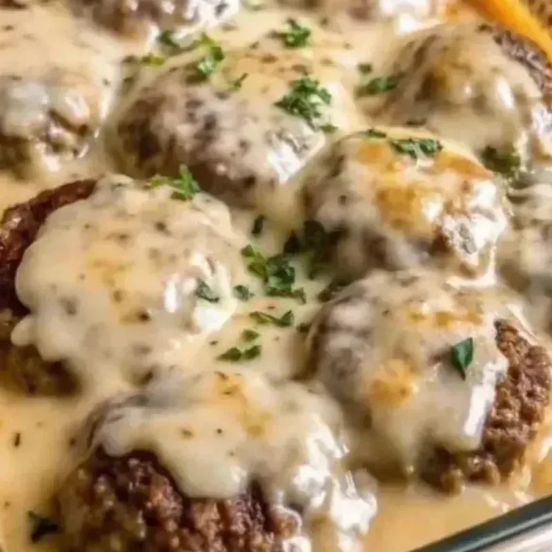 Amish Hamburger Steak Bake served in a rustic dish with rich gravy and seasonings.
