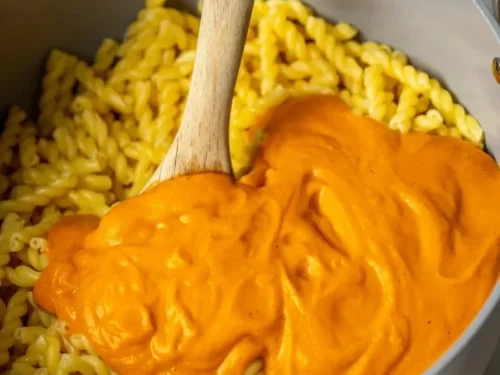 Delicious bowl of butternut squash pasta sauce with herbs and cheese