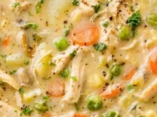 Delicious homemade Chicken Pot Pie Soup served in a bowl with ingredients.