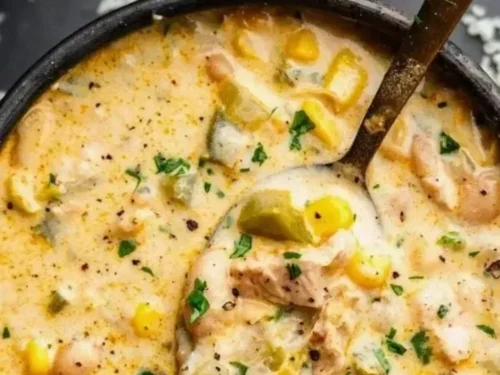 Creamy cheesy chicken white chili served in a bowl with toppings