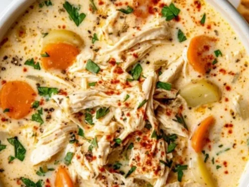Crockpot creamy chicken and potato soup in a bowl garnished with herbs