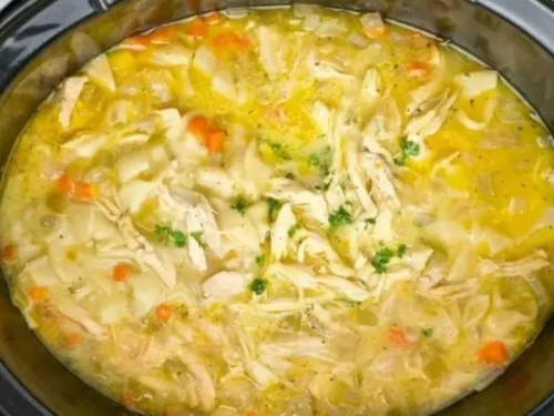 Crockpot Creamy Chicken Noodle Soup in a bowl garnished with parsley