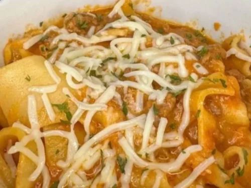 Delicious crockpot lasagna soup topped with cheese and herbs in a bowl.