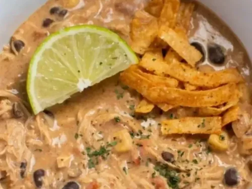 Crockpot White Chicken Chili with Cream Cheese topped with cilantro and jalapeños