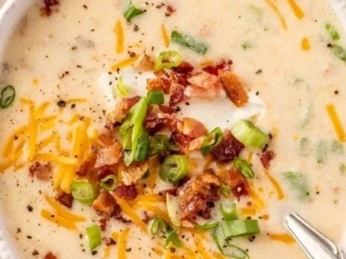 Bowl of creamy easy crockpot potato soup with garnishes