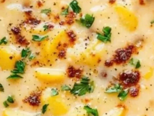 Bowl of creamy Instant Pot Cajun Potato Soup garnished with herbs and spices
