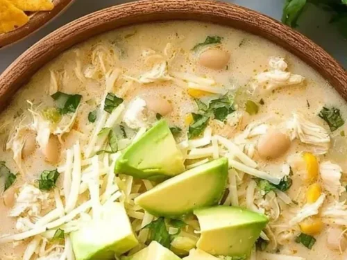 Bowl of mouthwatering white chicken chili topped with cilantro and lime