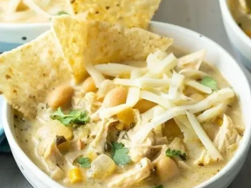 Bowl of delicious white chicken chili topped with cilantro and avocado
