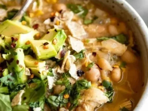 Bowl of creamy white chicken chili topped with cilantro and jalapeños