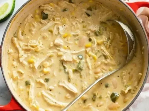 Bowls of white chicken chili topped with fresh cilantro and jalapeños
