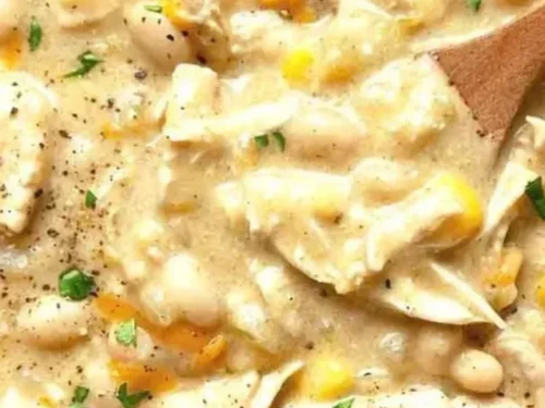Delicious bowl of creamy White Chicken Chili topped with cilantro and jalapeños.