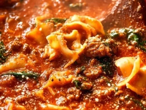 Bowl of best ever one-pot lasagna soup topped with cheese and fresh herbs.