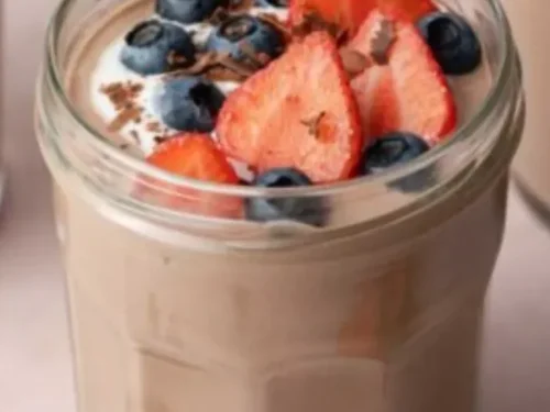 Delicious Chocolate Protein Pudding topped with berries and chocolate shavings
