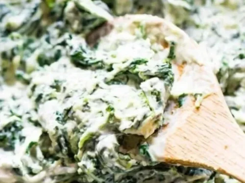 Cream cheese spinach stuffed chicken breast served on a plate