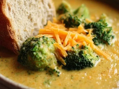 Bowl of Panera broccoli cheddar soup garnished with bread for a cozy meal
