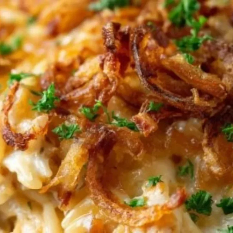 French onion chicken orzo casserole dish garnished with herbs