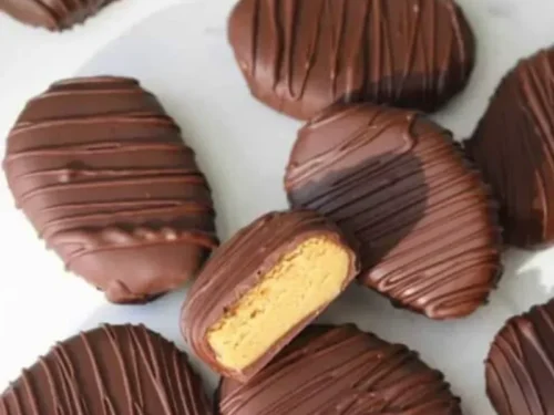 Homemade healthy peanut butter eggs topped with chocolate, a nutritious treat.