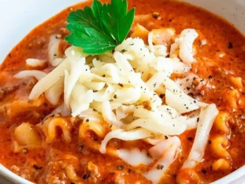 A bowl of delicious lasagna soup topped with cheese and herbs.