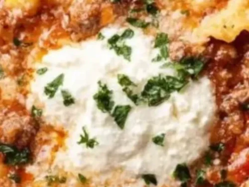Creamy no noodle lasagna soup served in a bowl with fresh herbs