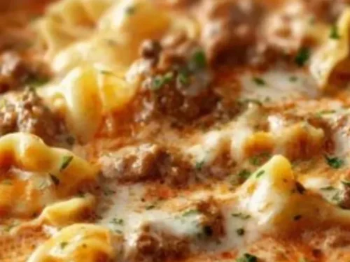One Pot Lasagna Soup in a bowl, garnished with herbs and cheese.