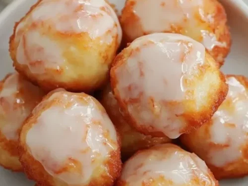Delicious air fryer apple fritters ready to serve with a light dusting of powdered sugar.