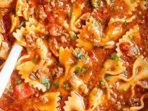 Bowl of delicious lasagna soup topped with cheese and herbs