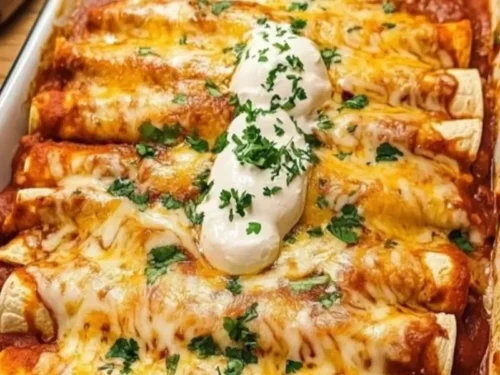 Delicious quick and easy chicken enchiladas served on a plate with garnishes.
