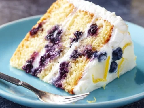 Slice of lemon blueberry cake with vibrant layers of lemon and blueberries