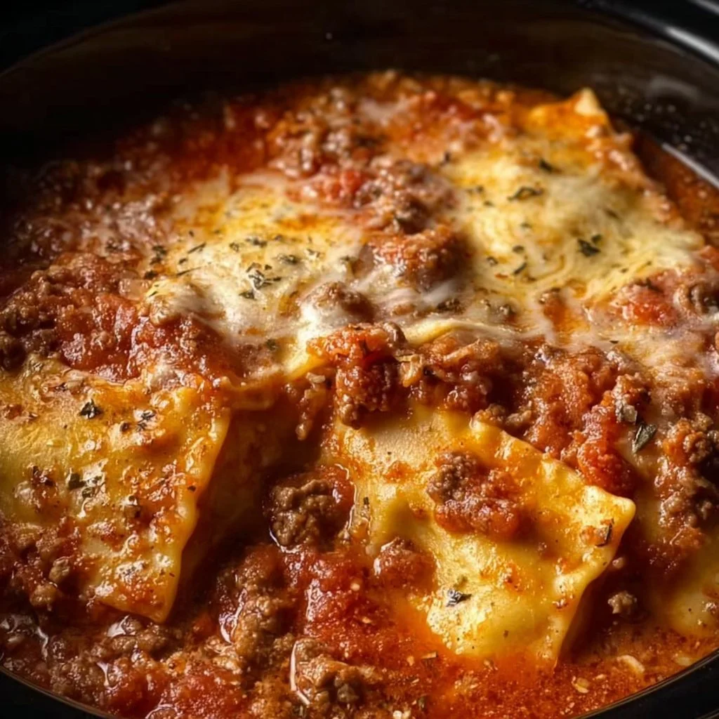 Delicious Crockpot Ravioli Lasagna served in a ceramic dish with melted cheese.