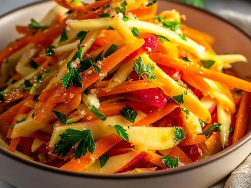 Bowl of delicious carrot apple salad with fresh ingredients