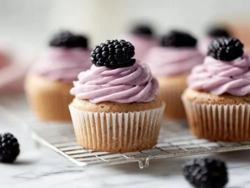 Earl Grey Blackberry Cupcakes topped with fresh blackberries and cream