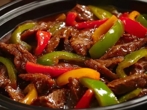 Easy Crock Pot Pepper Steak with beef and vegetables in a slow cooker.