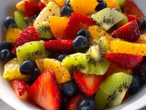 Bowl of fresh fruit salad with honey lime poppy seed dressing