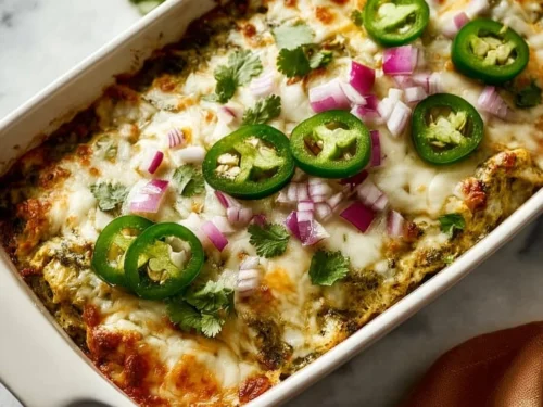 A healthy salsa verde chicken casserole topped with fresh ingredients.