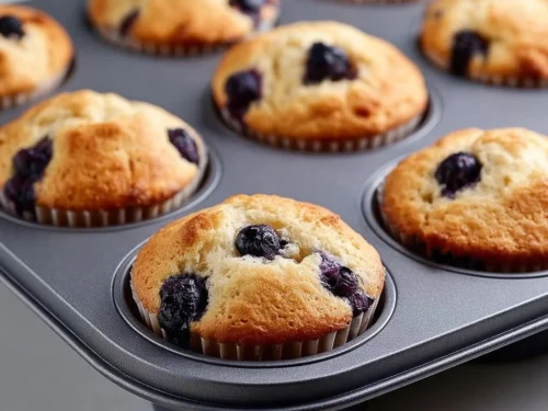 Freshly baked hearty blueberry protein muffins on a wooden table