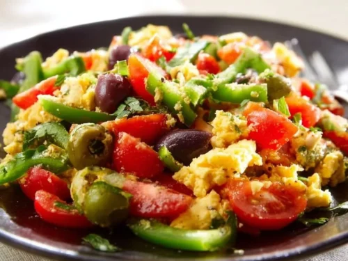 Colorful Mediterranean breakfast bowl with fresh vegetables and grains