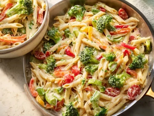 Colorful Pasta Primavera with fresh vegetables and herbs in a bowl