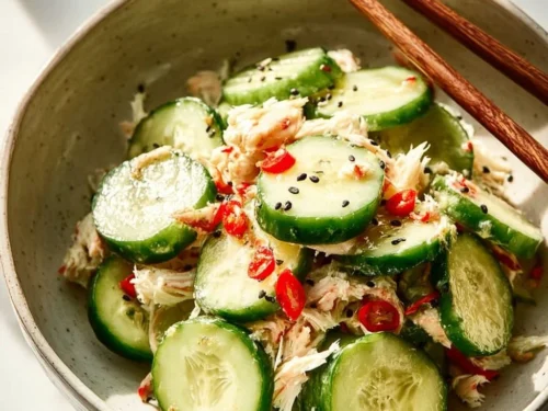 Delicious California Roll Cucumber Salad served in a bowl, garnished with sesame seeds.